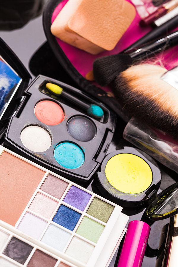 Close up brushes and cosmetic products on the table, vivid colors